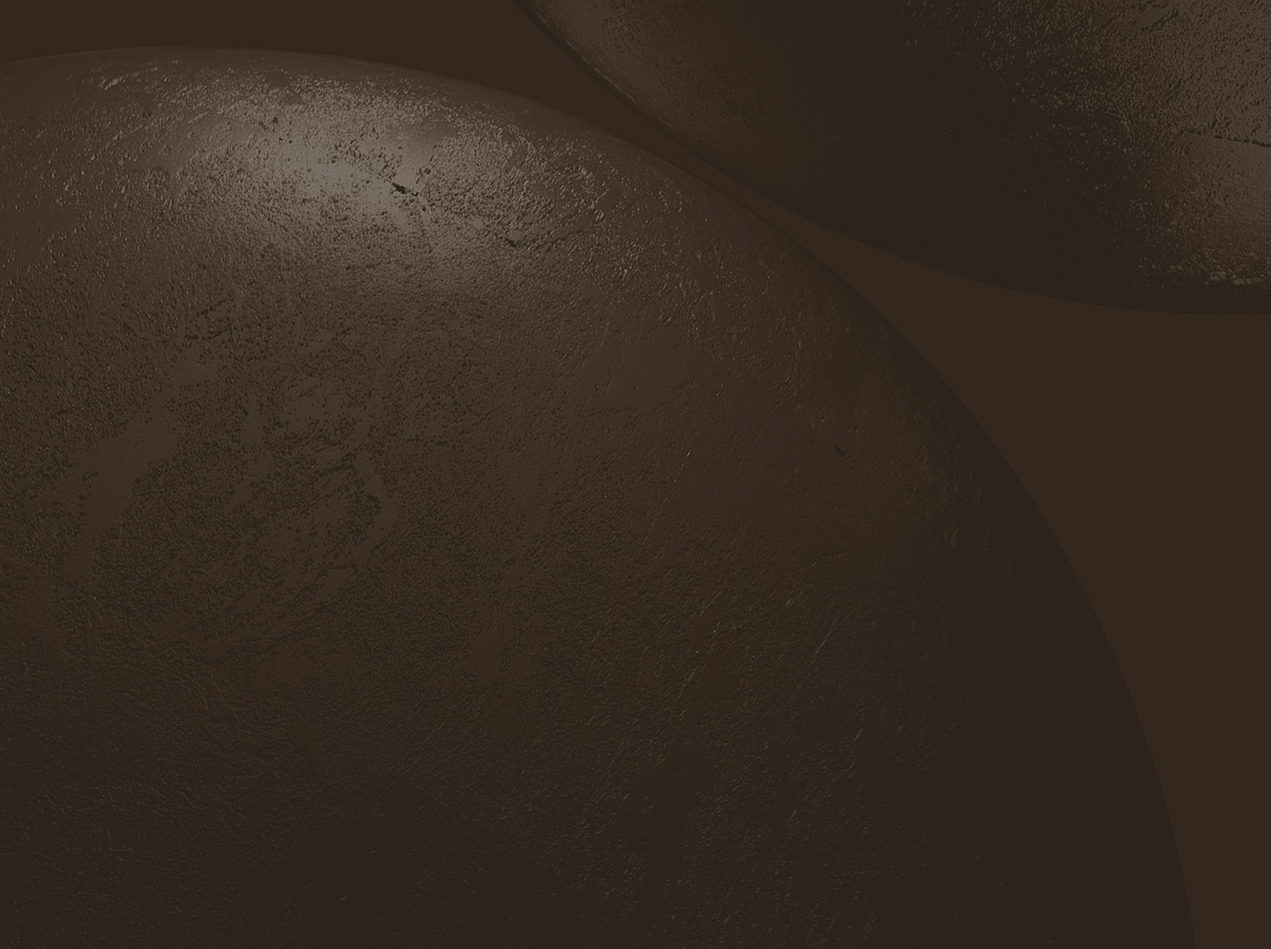Dark, textured surface with curved shapes.