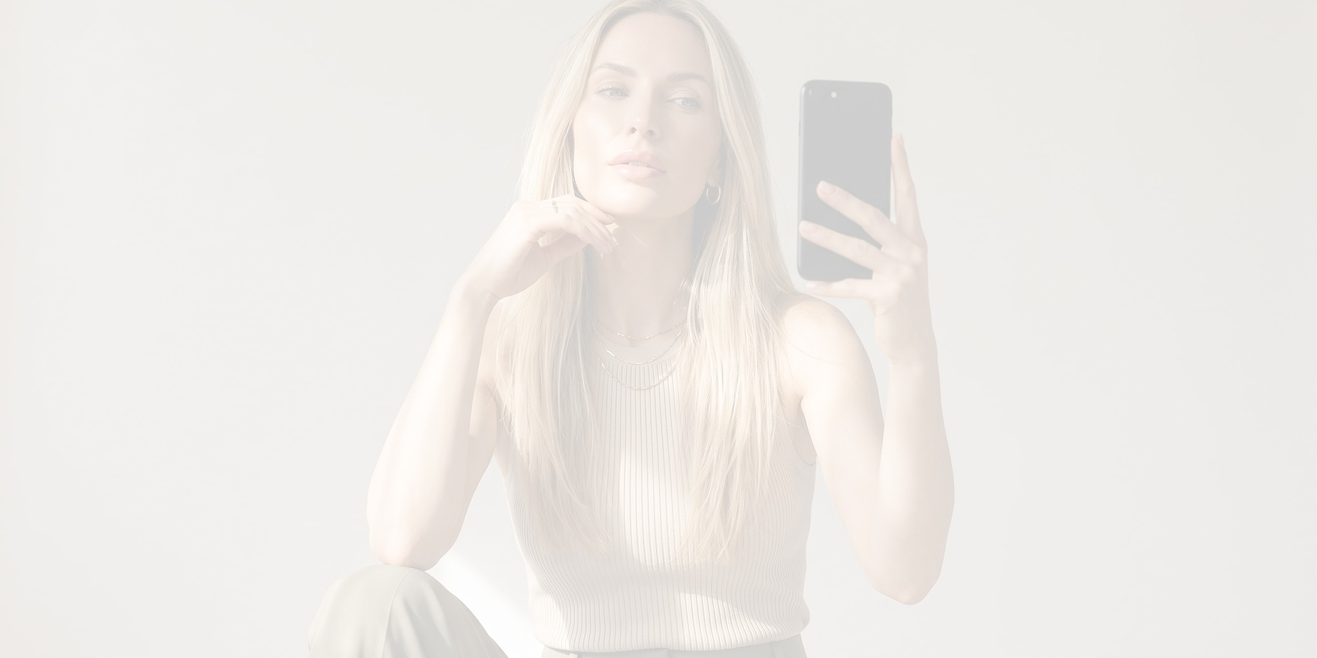 Woman taking a selfie with natural makeup.
