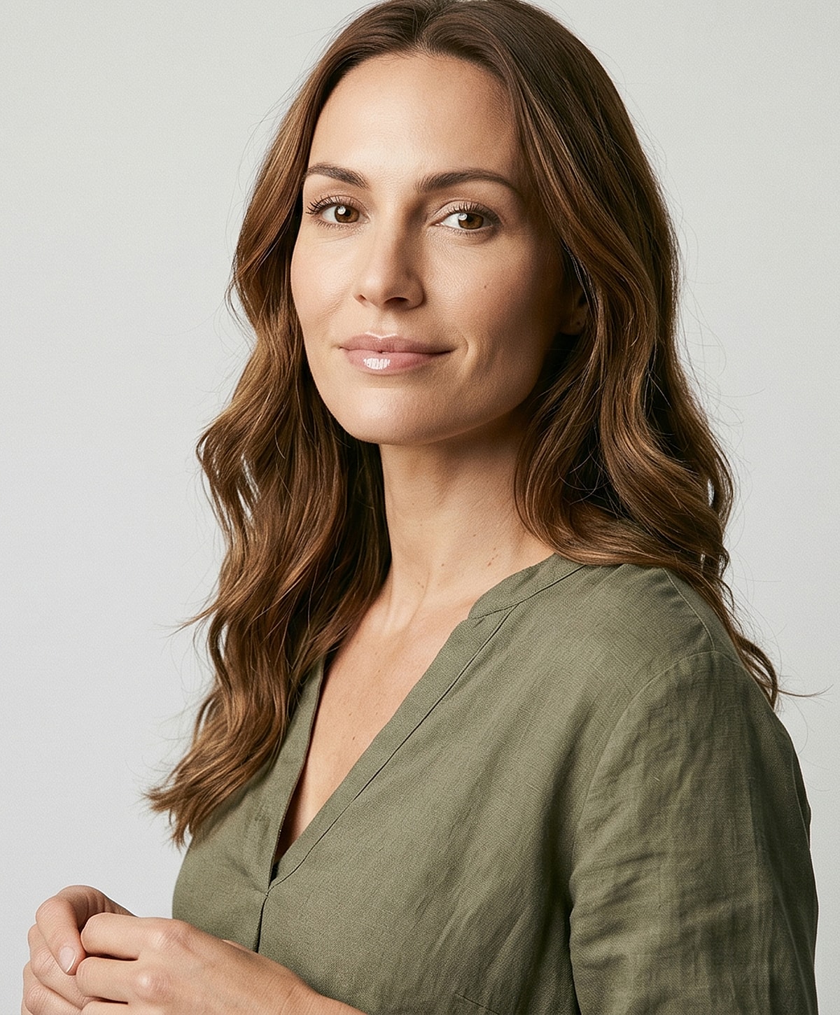 Woman with long hair in green blouse.