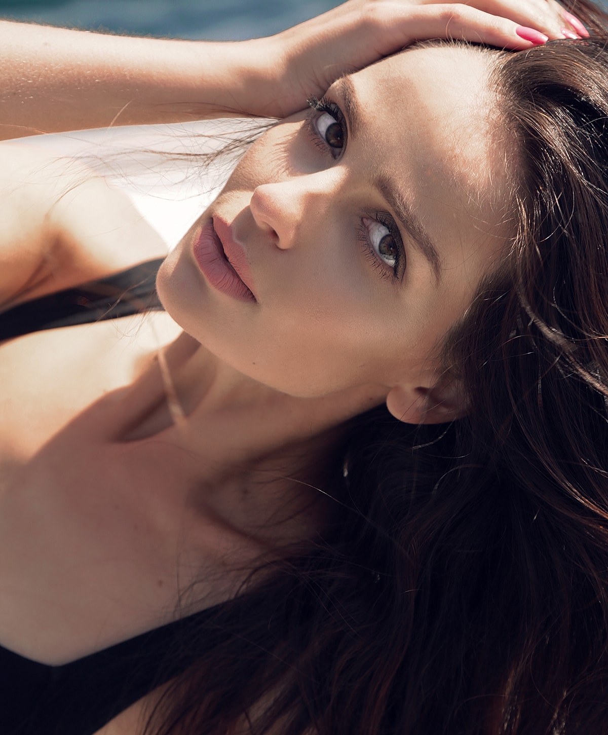 Young woman with long hair, natural lighting.