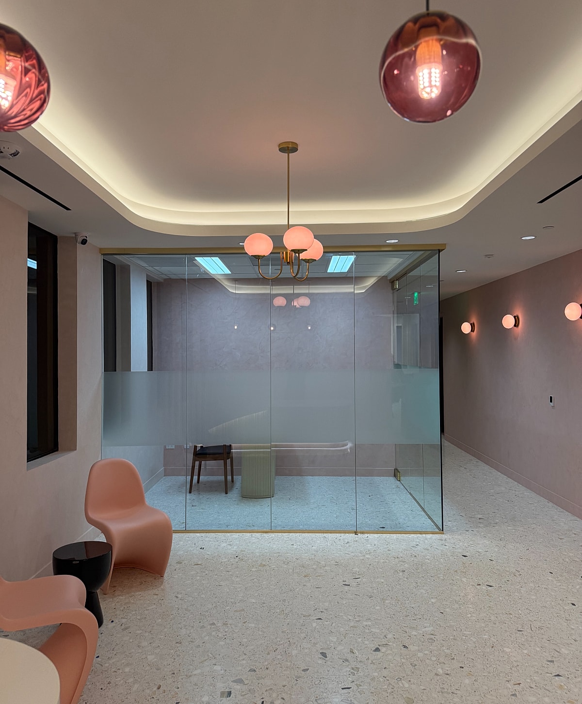 Modern office space with glass meeting room.