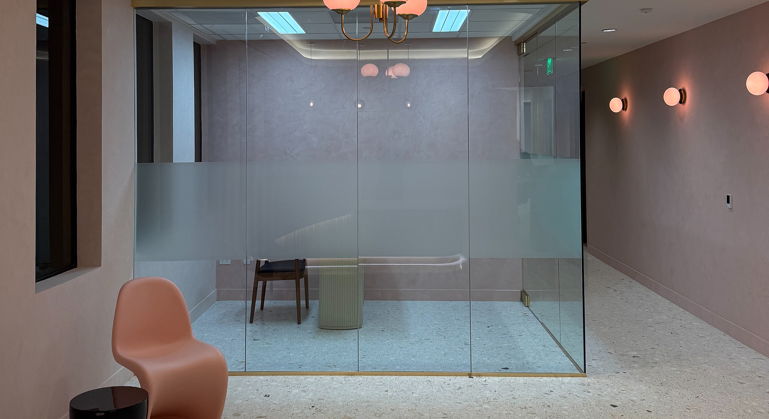 Modern office space with glass wall and decor.