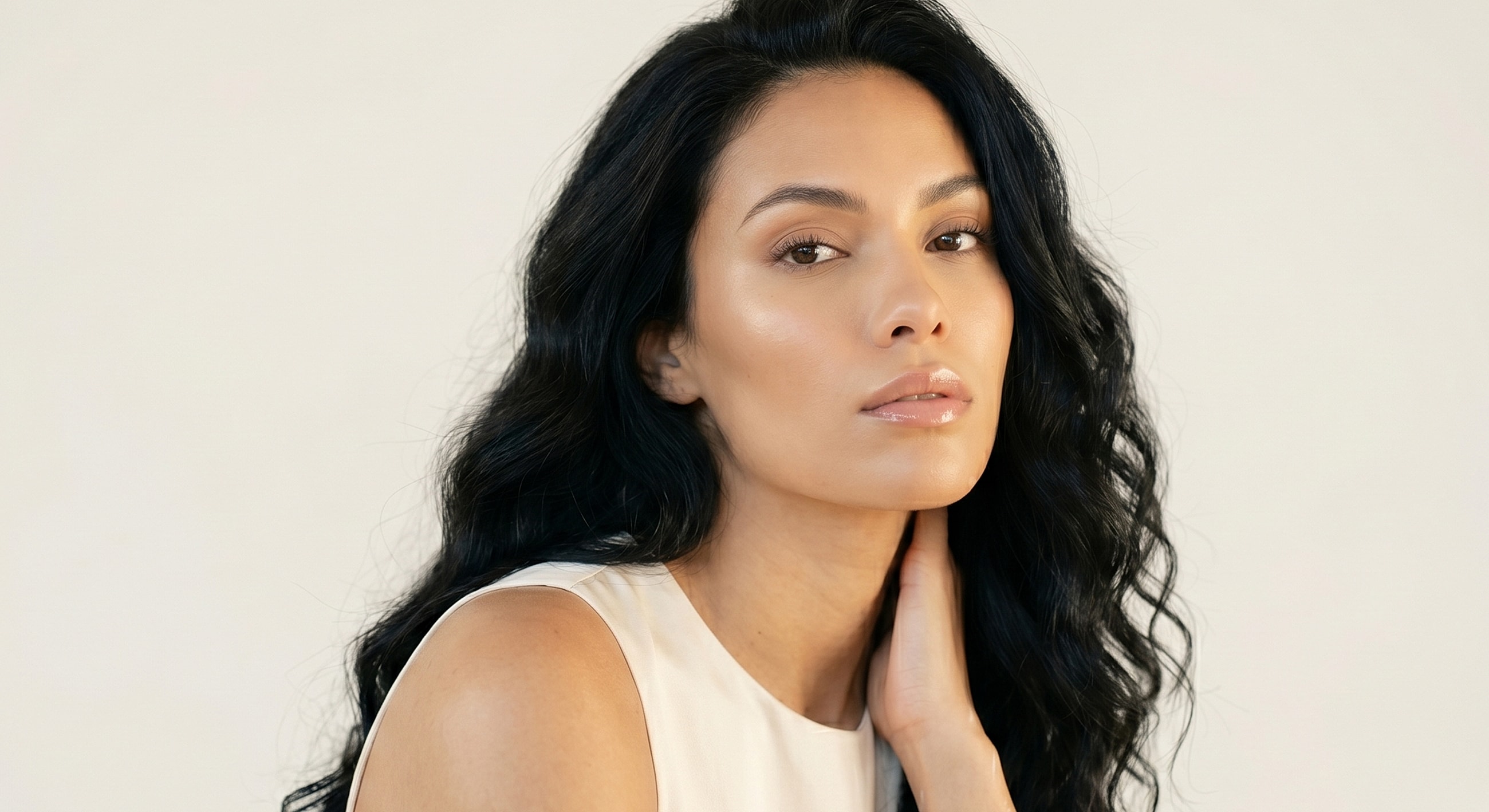 Close-up of woman with wavy black hair.