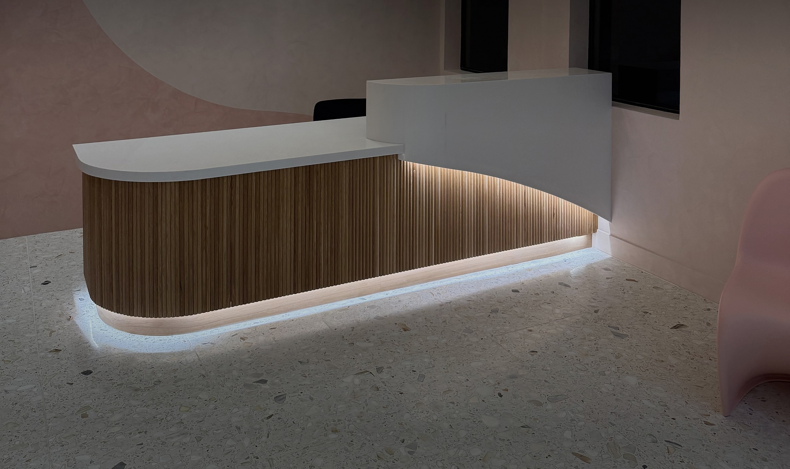 Modern reception desk with ambient lighting design.